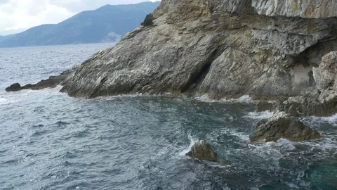Cave Cliffs Washed by Waves Stock Footage 77354637