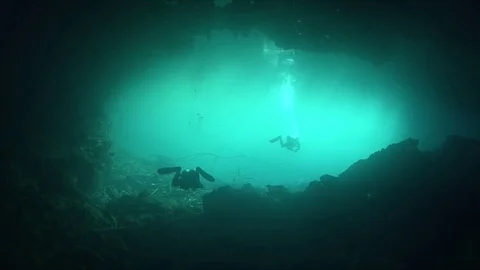 Cave divers entering/exiting underwater cave system Stock Footage 83102616