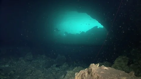 Cave divers entering/exiting underwater cave system Stock Footage 83102977