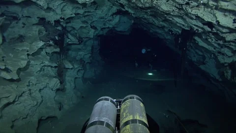 Cave divers exploring underwater cave system Stock Footage 83102357
