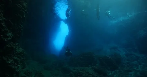 Cave diving underwater exploring caves ocean sun beams and rays background Stock Footage 164280083