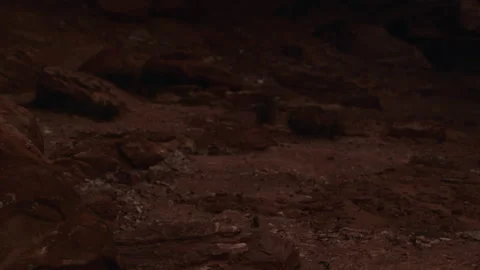 Cave exploration at night with rocky terrain and dim light conditions Stock Footage 338158986