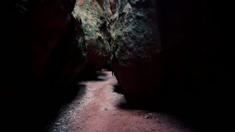 Cave exploration young explorer walks through a narrow cavern exploring Vídeo Stock 178928053