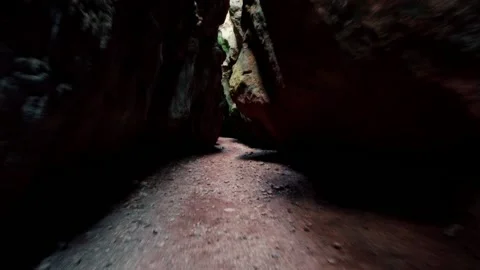 Cave exploration young explorer walks through a narrow cavern exploring 動画素材 178930567
