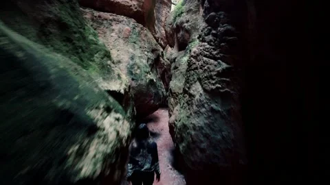 Cave exploration young explorer walks through a narrow cavern exploring Video stock 178940044
