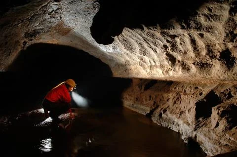 Cave explorer, speleologist exploring the underground Stock Photos