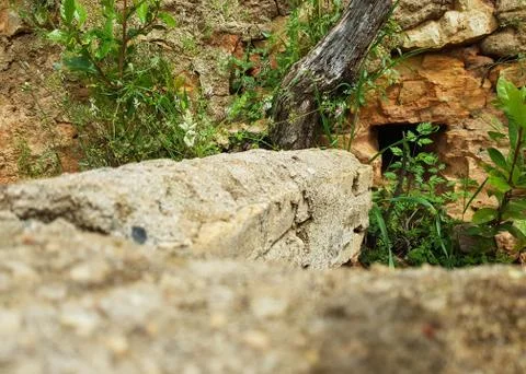 Cave framed by stone wall Stock Photos