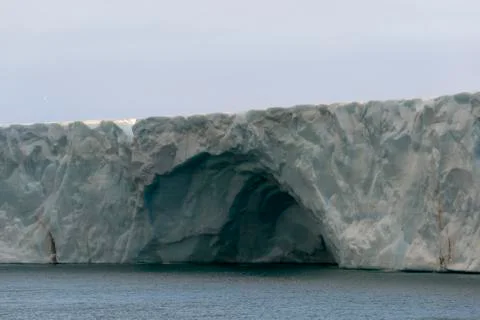 Cave in ice wall Stock Photos
