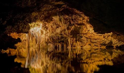 Cave with illuminated stalactites Stock Photos