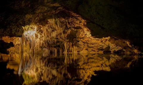Cave with illuminated stalactites Stock Photos