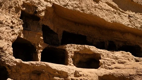 Cave openings on the rocky surface of mountain side. Video stock 106321860