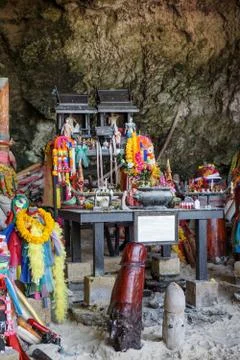 The cave at the Phra Nang beach in thailand houses a small temple whit lots o Stock Photos