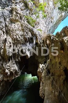 Cave in rock filled with river water. Glare on the stone surface of the mains Stock Photos