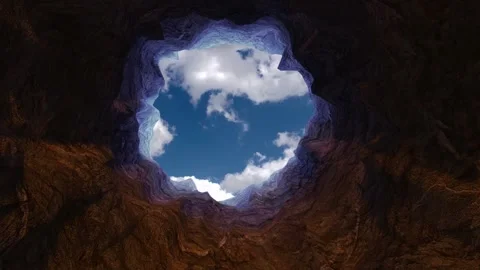 Cave rock tunnel opens up towards the blue sky with time lapse clouds Stock Footage 248952046