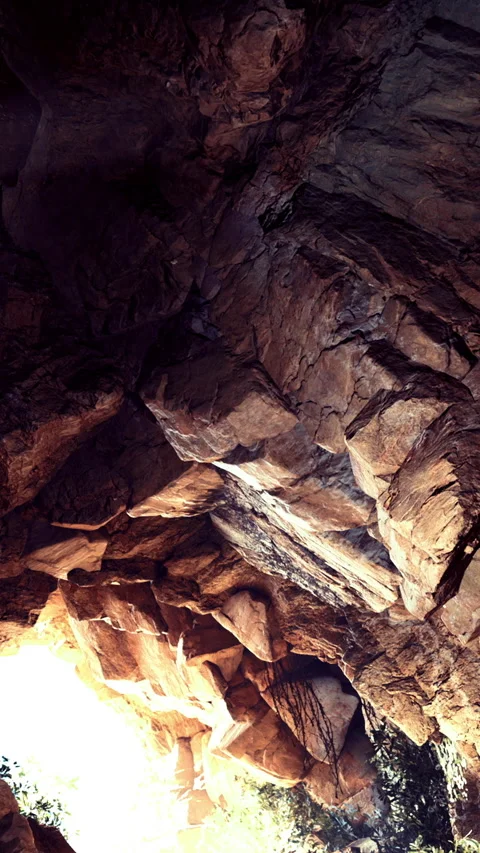 Cave with rocky ceiling and natural light shining through entrance Stock Footage 331748364