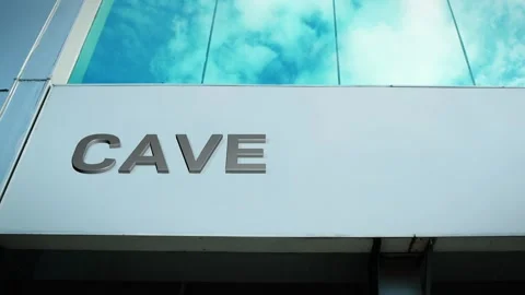 Cave Sign on Modern Building with Cloud Reflection on Windows Glass Stock Footage 303554313