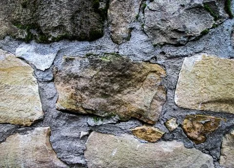 Cave stone laying. The old wall is light with brown mineral. Stock Photos