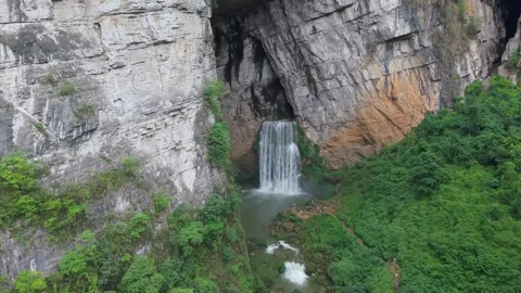 Cave waterfalls in strange terrain Stock Footage 311742553