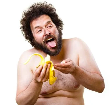 Caveman eating a banana Stock Photos