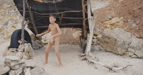 Caveman, manly boy dancing . Funny young primitive boy outdoors. Prehistoric Stock Footage 115767486