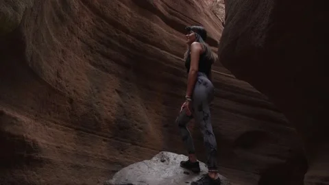 Caver with headlamp standing on a boulder in a cave Stock Footage 346910015
