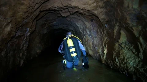 Caver Preparing to Dive in an Abandoned Gallery, for her Research Stock Footage 104242144