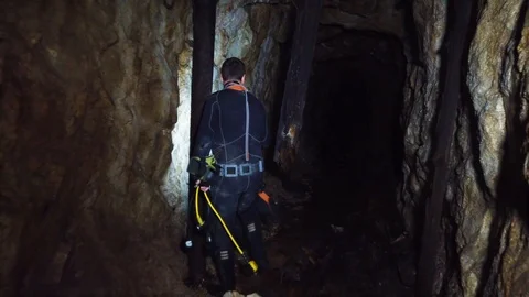 Caver Preparing to Dive in an Abandoned Gallery, for her Research Stock Footage 104247067