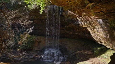 Cavern Falls: A Luminous Veil Within the Earth’s Rocky Embrace Stockbeeldmateriaal 323975640