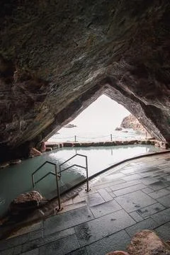 Cavernous hot spring bath with a beautiful view of the Pacific Ocean Stock Photos