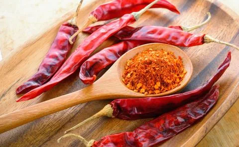 Cayenne pepper in a spoon Stock Photos