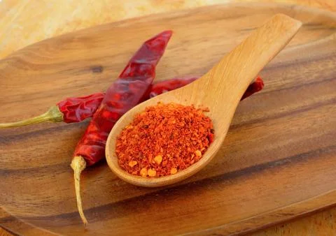 Cayenne pepper in a spoon Stock Photos