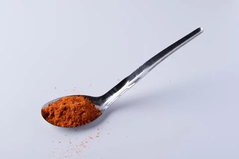 Cayenne pepper in a spoon on a white background Foto stock