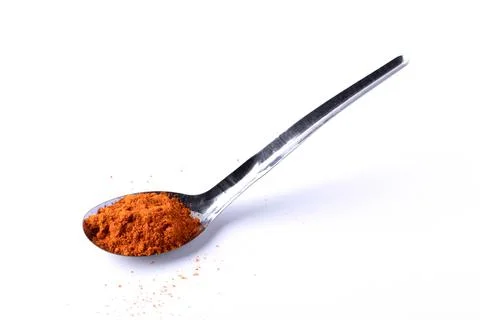 Cayenne pepper in a spoon on a white background Stock Photos