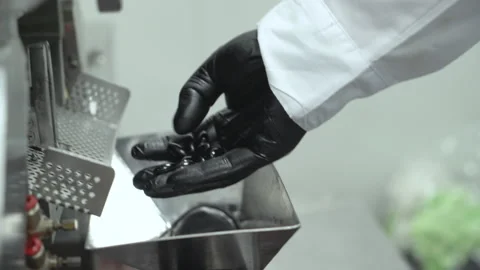 Cbd capsule manufacture close up of hand checking quality Stock Footage 160034318
