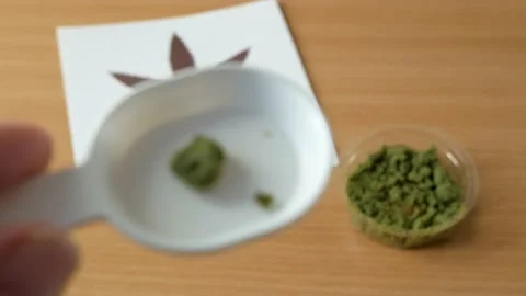 CBD Hemp pills and extract. Cannabis drugs, marijuana buds and dry grass. Can Stock Footage 200778043