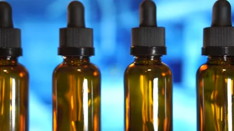 CBD oil in a laboratory, close-up macro cannabis oil bottles Stockbeeldmateriaal 143888523