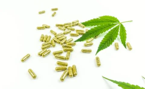 CBD pills. Group of clear CBD Cannabidiol capsules and hemp leaf isolated on  Stock Photos
