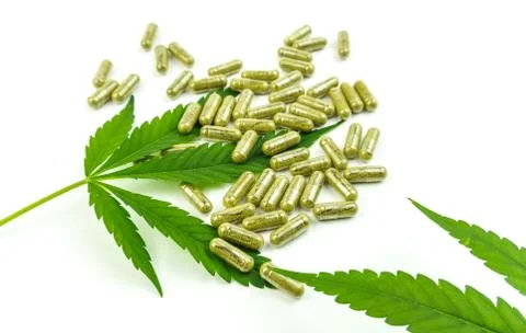 CBD pills. Group of clear CBD Cannabidiol capsules and hemp leaf isolated on  Stock Photos