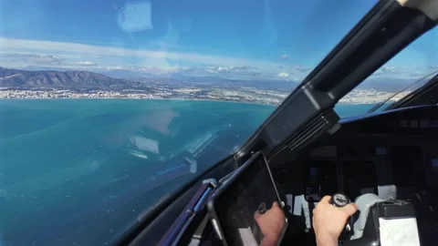 Ccckpit View: Pilot Taking the Manual Control of a Jet Airplane in the Approach Stock Footage 328296596