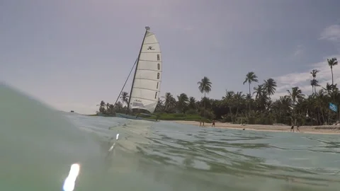 In the ccean looking at a small boat on a sunny day Stock Footage 185095889