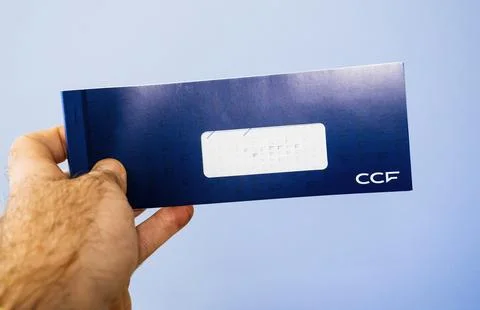CCF Envelope Held Against Blue Background Stock Photos