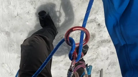 Cclimber climbs down a rope using a descent device Stock Footage 246292614