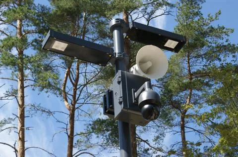 CCTV and speaker on lantern. Stock Photos