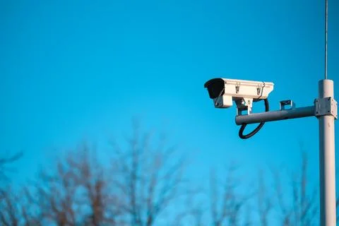 CCTV Camera on Blue Sky Background Stock Photos