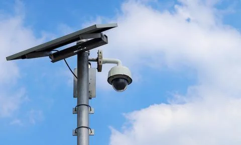 CCTV camera on bright blue sky background, Concept. 24 hour day and night s.. Stock Photos