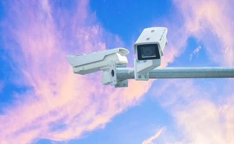CCTV camera on bright sky background 24 hour security equipment Stock Photos