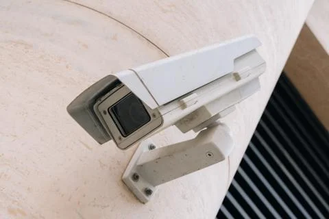 The ccTV camera is closeup against the background of the light business cente Stock Photos