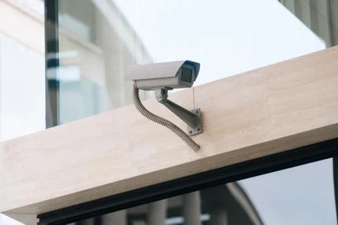 The ccTV camera is closeup against the background of the light business cente Stock Photos