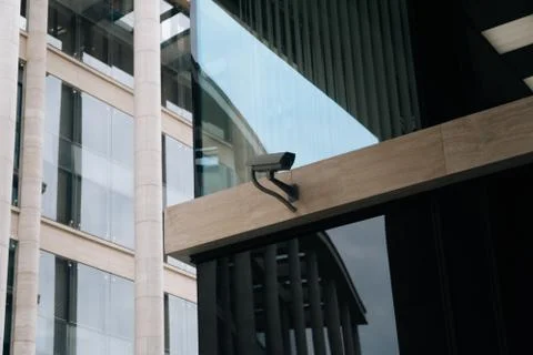 The ccTV camera is closeup against the background of the light business cente Stock Photos