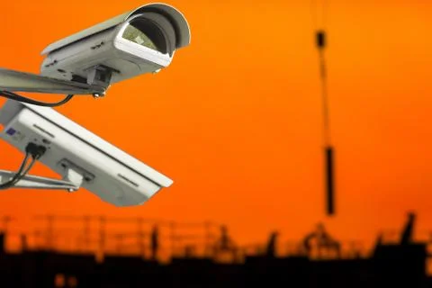 CCTV camera concept with silhouettes of workers on a building site in the bac Foto stock